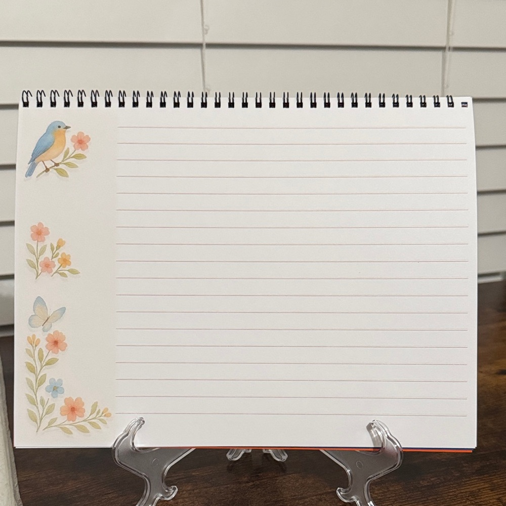 Floral Spiral Notebook with Bird Design in landscape layout.